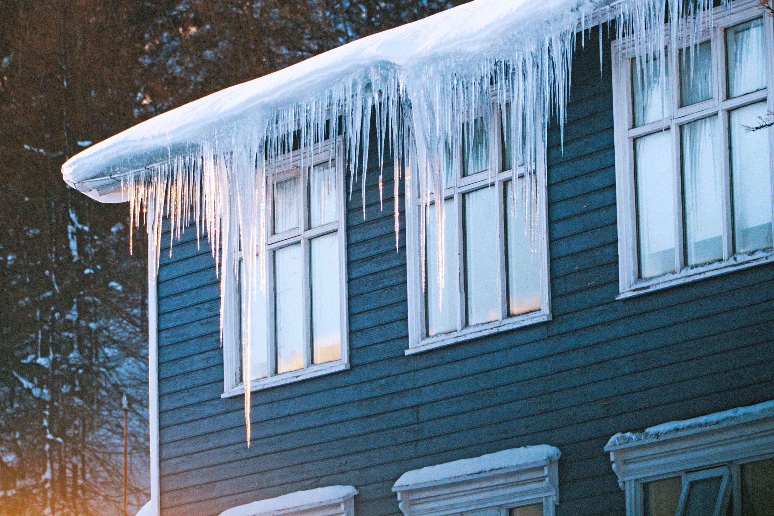A house with icicles hanging from the roof.