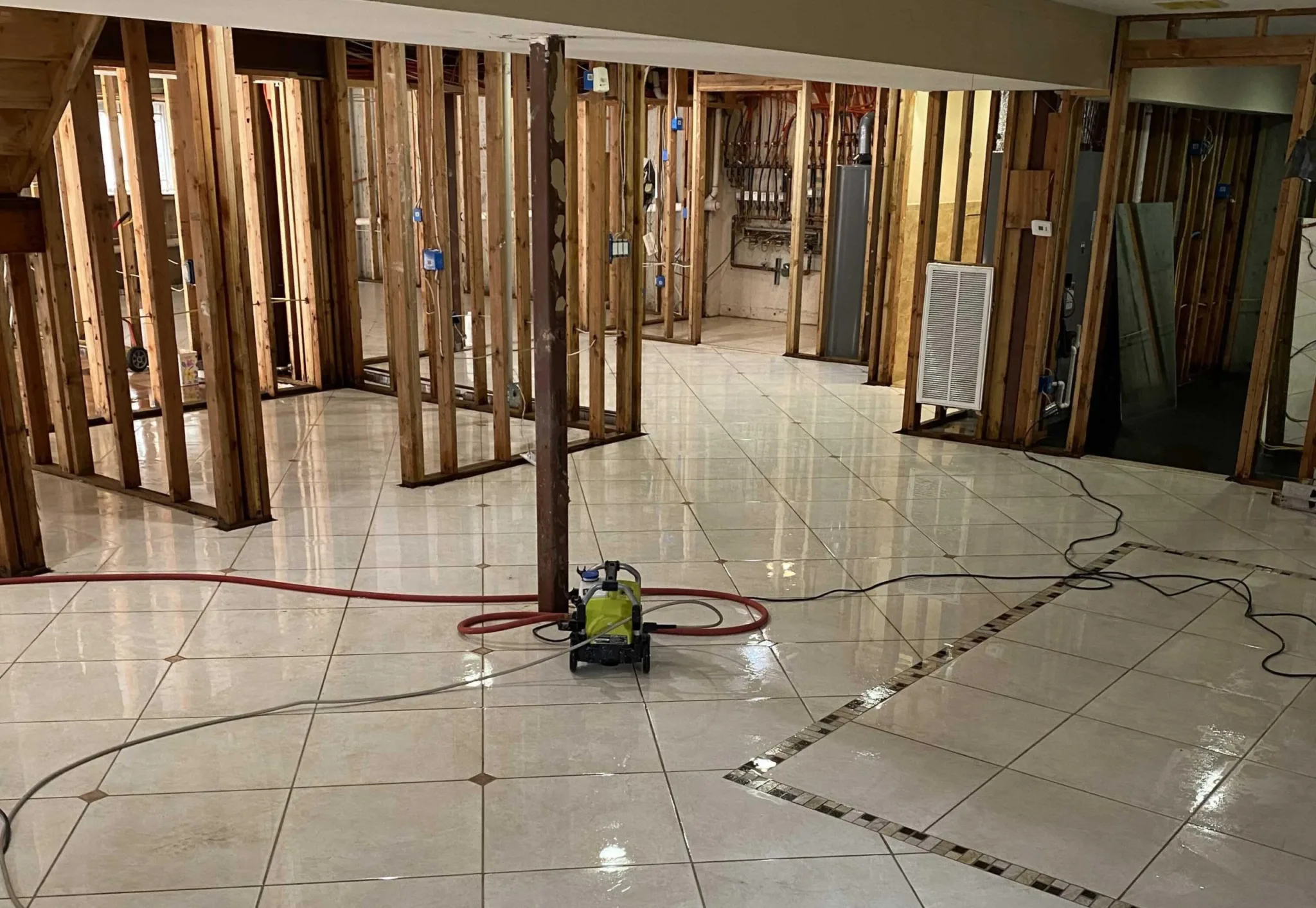 A room with a floor being remodeled and the walls are being removed.