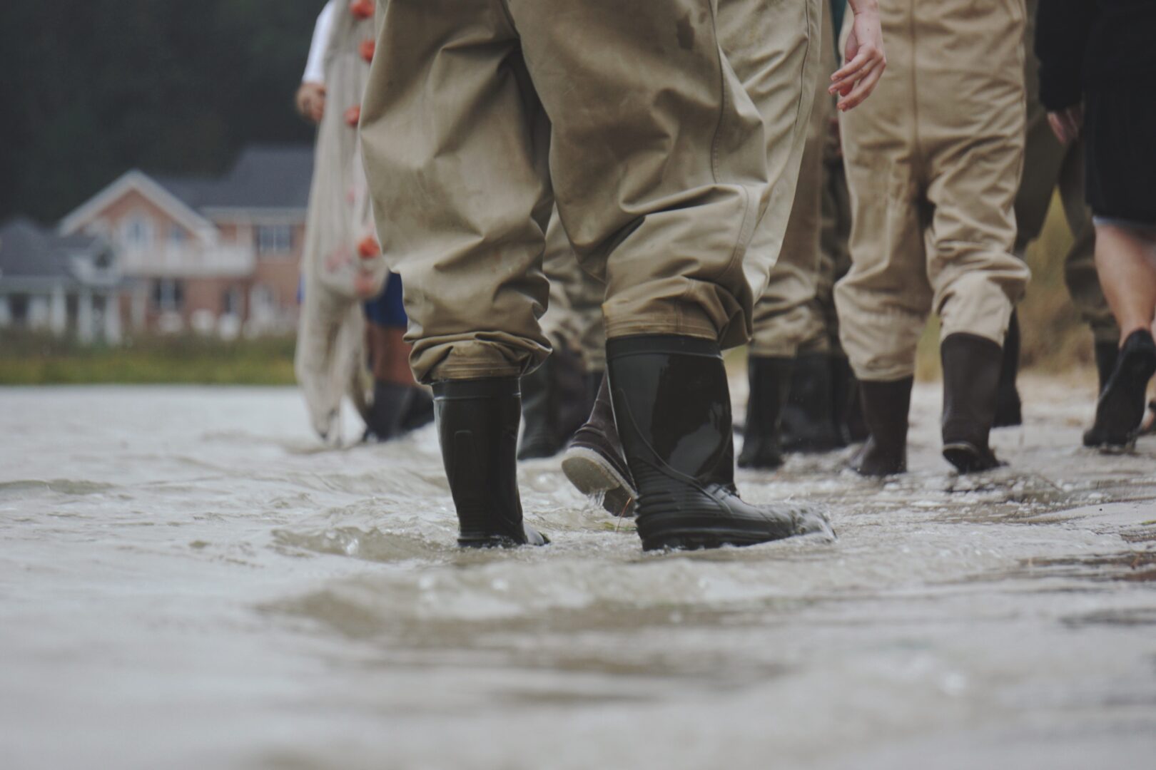 A close up of some people in waders walking through water