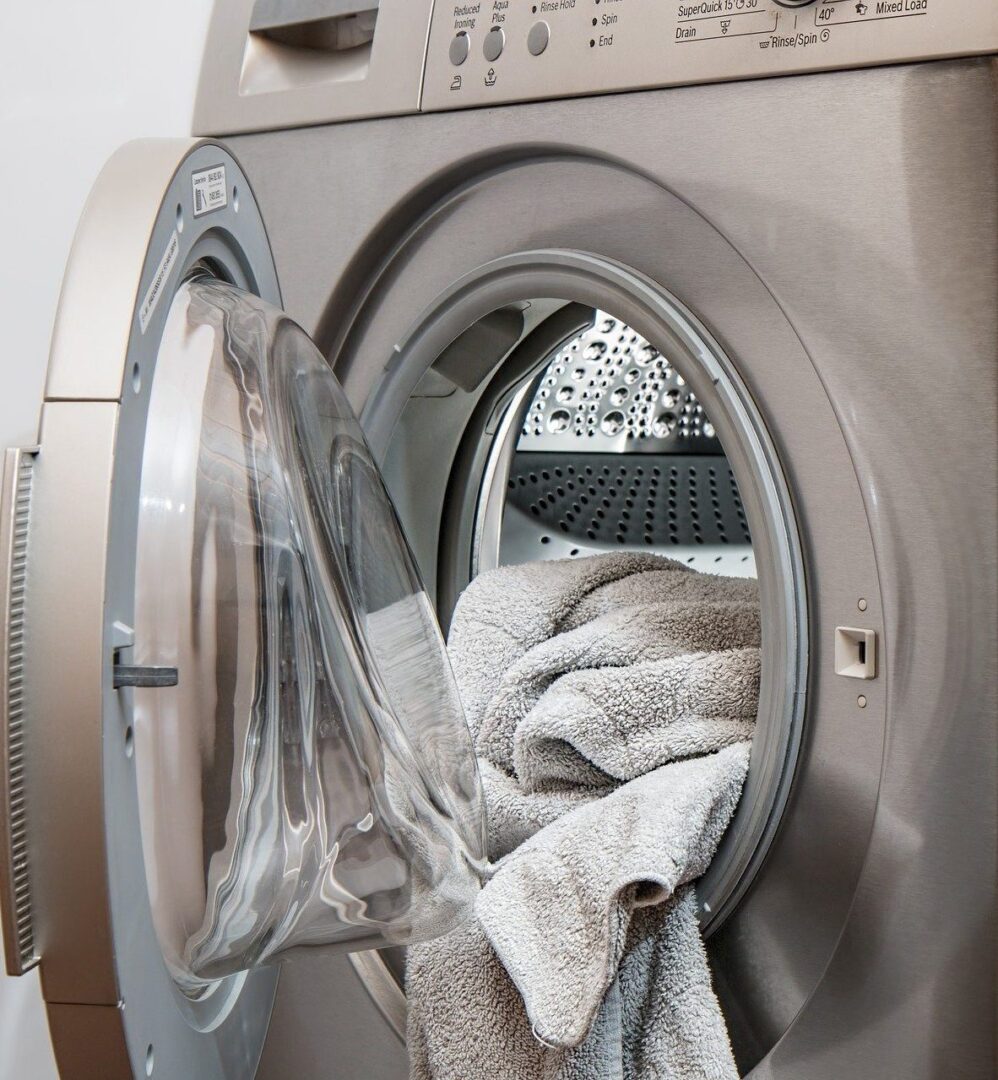 A washing machine with some towels in it